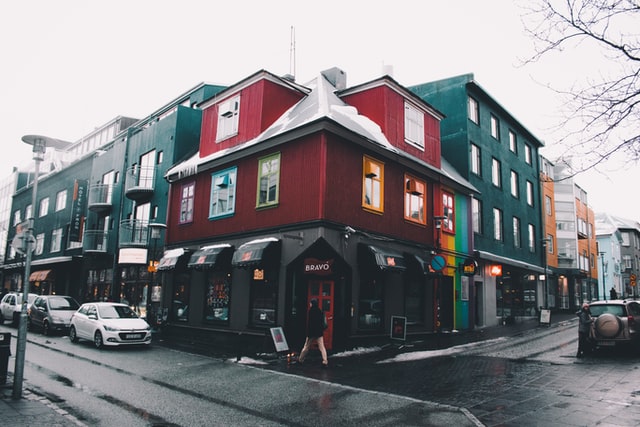 image showcasing a corner store with homes on second and third floors of building